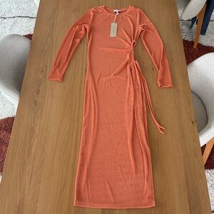 Long sleeved orange dress with side cut out. Stretchy material. Size M. Acoa